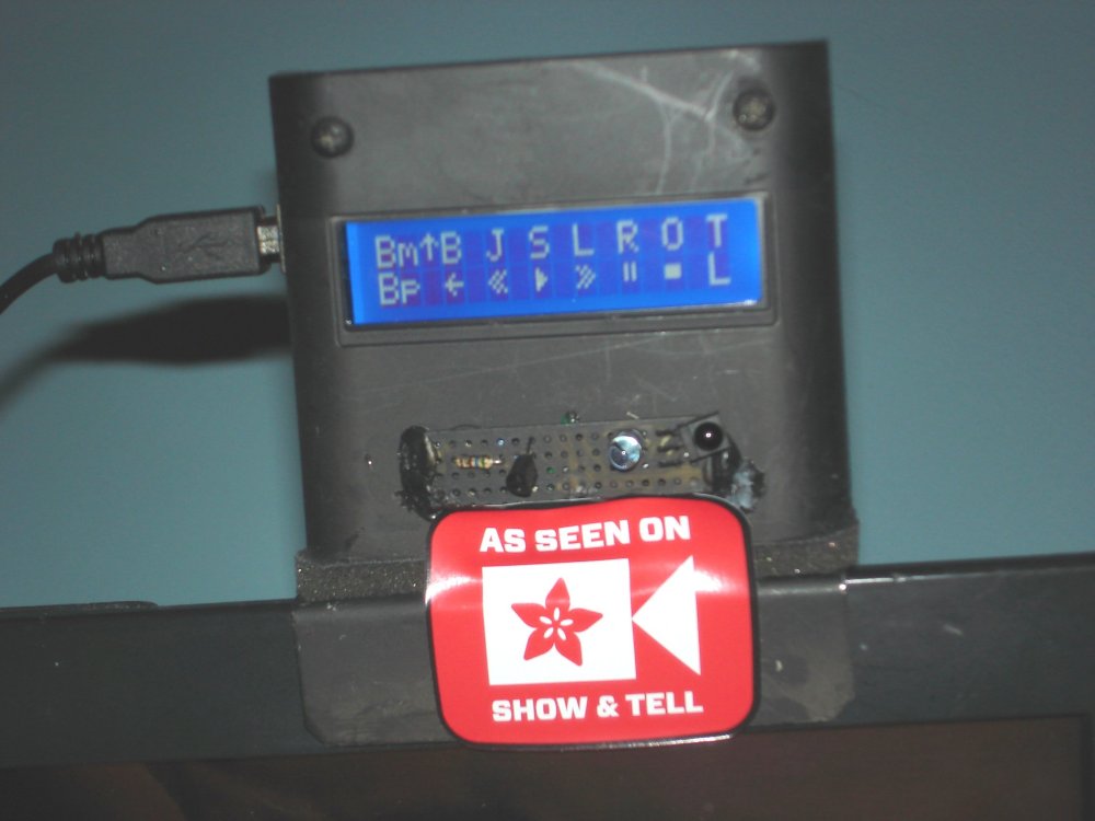 Arduino-based device with LCD menu sits atop my TV probably displaying an Adafruit "As Seen on Show & Tell" sticker.