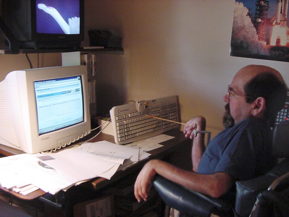 Me checking my stock portfolio using stick and keyboard on easel. Circa 2000